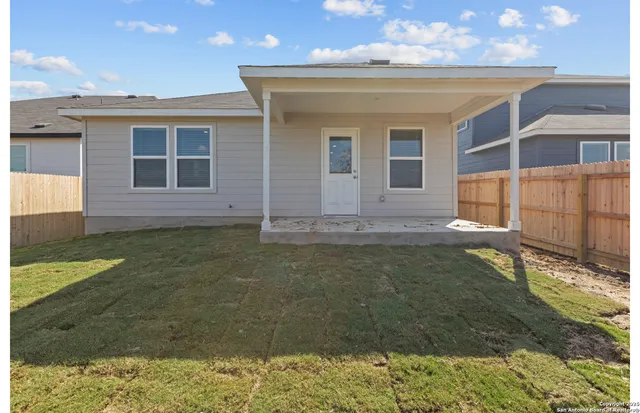a view of house with backyard