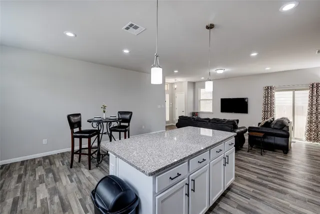 a view of workspace with wooden floor and piano
