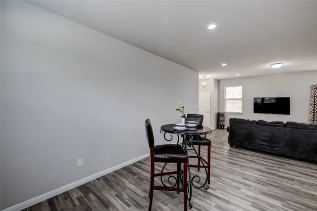 a kitchen with granite countertop a sink stove and refrigerator