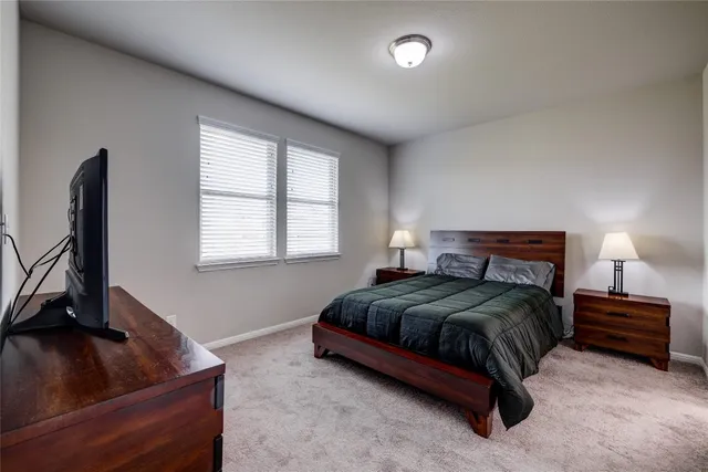 a kitchen with stainless steel appliances a refrigerator a stove a sink dishwasher and a dining table with wooden floor