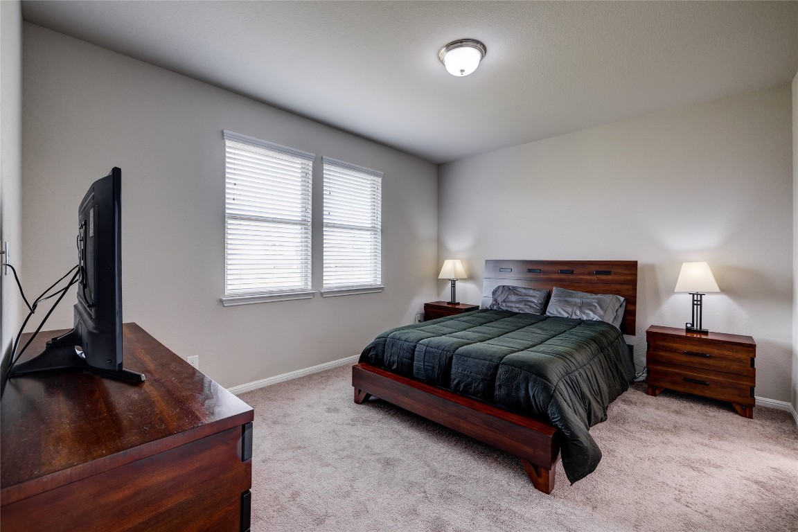 128 Shearwater Lane Leander, TX 78641 - Photo 20 of 30 a bedroom with a bed and a flat screen tv
