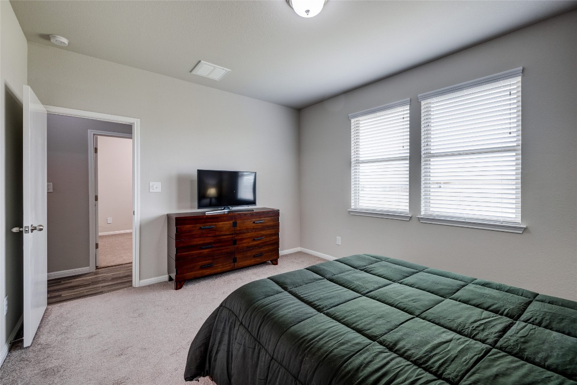 128 Shearwater Lane Leander, TX 78641 - Photo 21 of 30 a bedroom with a bed and a window