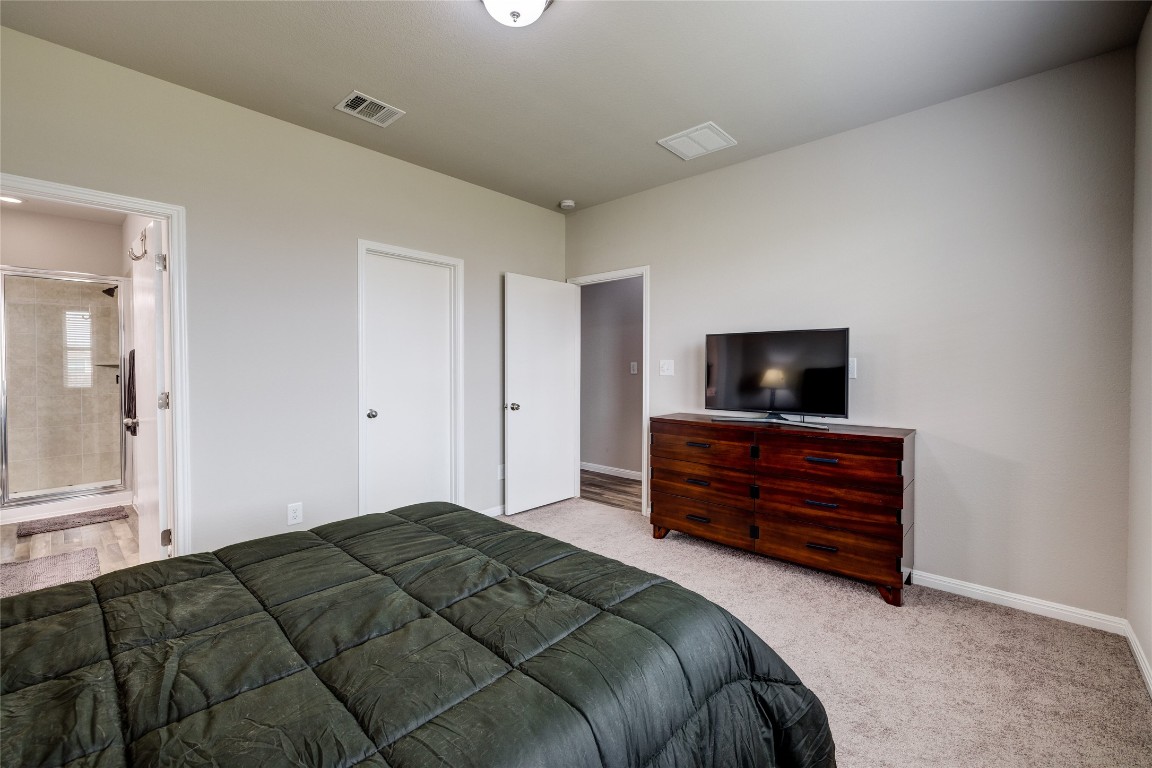 128 Shearwater Lane Leander, TX 78641 - Photo 22 of 30 a bedroom with a bed and a television