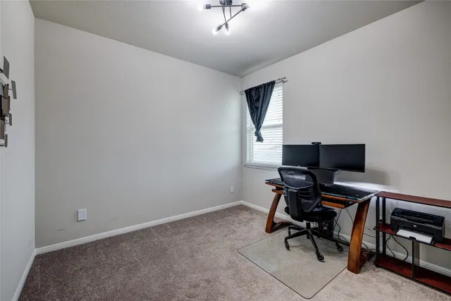 a bedroom with a bed and a lamp