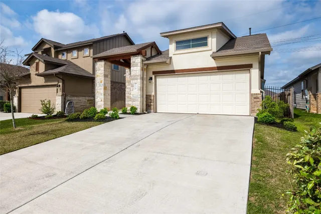 a front view of a house with a yard and garage