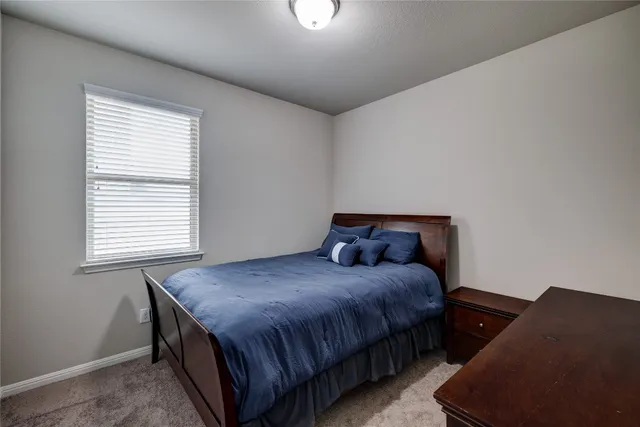 a bedroom with a bed and window