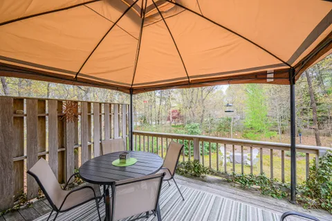 a view of a balcony with furniture and wooden floor