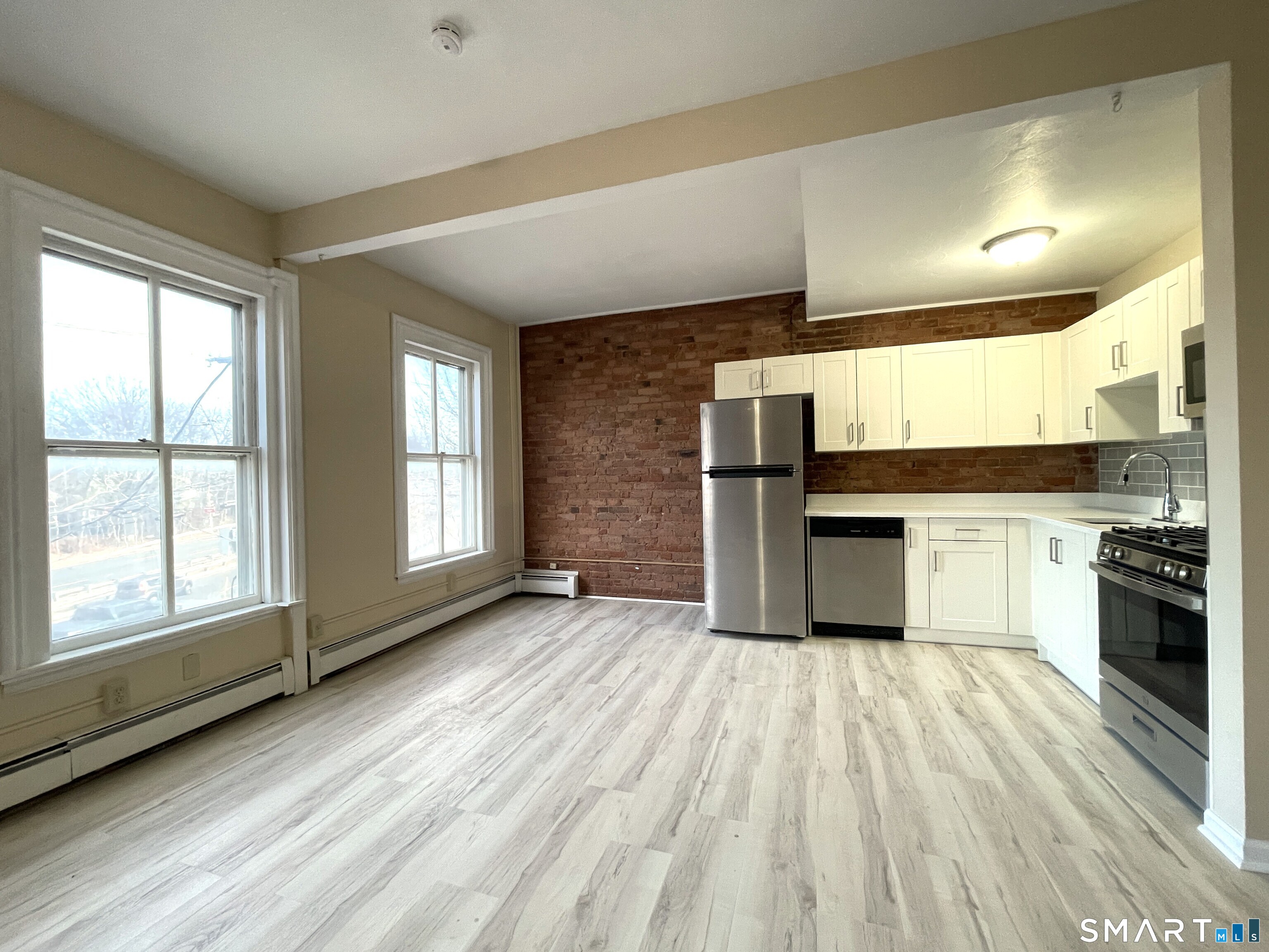 32 Trumbull Street, Unit 3 New Haven, CT 06511 - Photo 2 of 8 a kitchen with stainless steel appliances granite countertop a stove a sink and a refrigerator