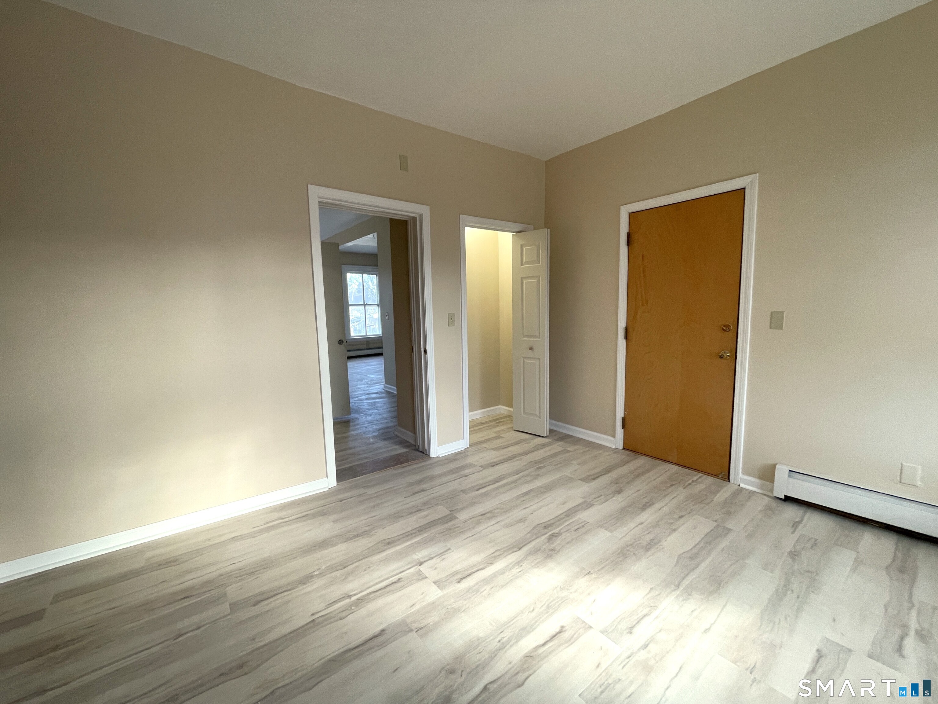 32 Trumbull Street, Unit 3 New Haven, CT 06511 - Photo 7 of 8 a view of an empty room with wooden floor and closet