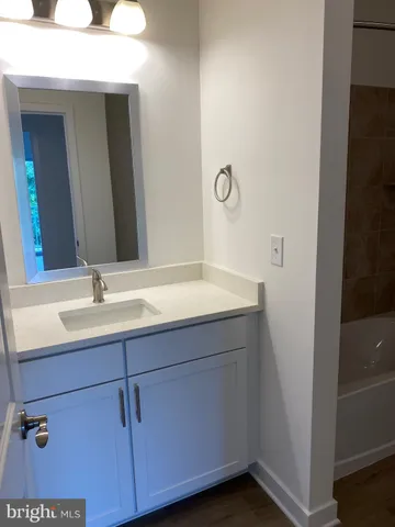 a white bath tub sitting next to a toilet