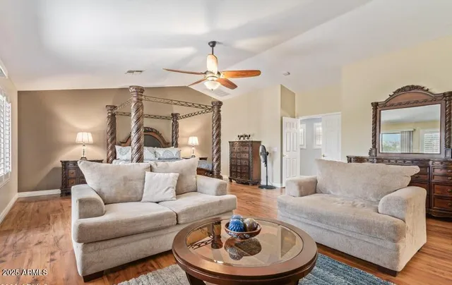 an empty room with a window and ceiling fan