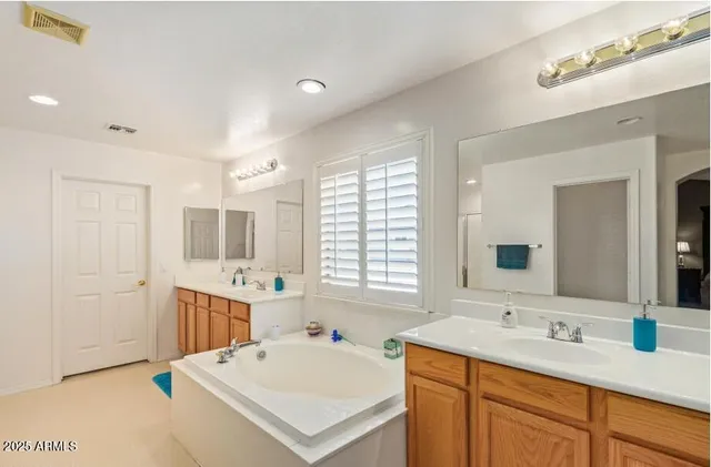 a bedroom with a bed dresser and a flat tv screen