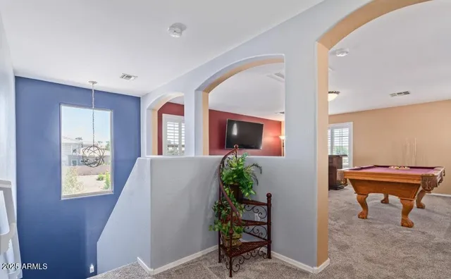 a dining room with furniture a chandelier and wooden floor