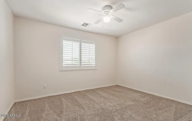 a living room with furniture a ceiling fan and a window