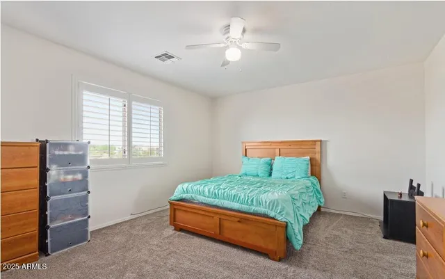 a view of walk in closet with clothes