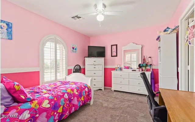 a bedroom with a bed and a television