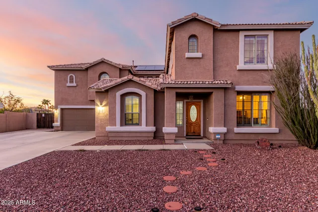 a view of a terrace with furniture and umbrella