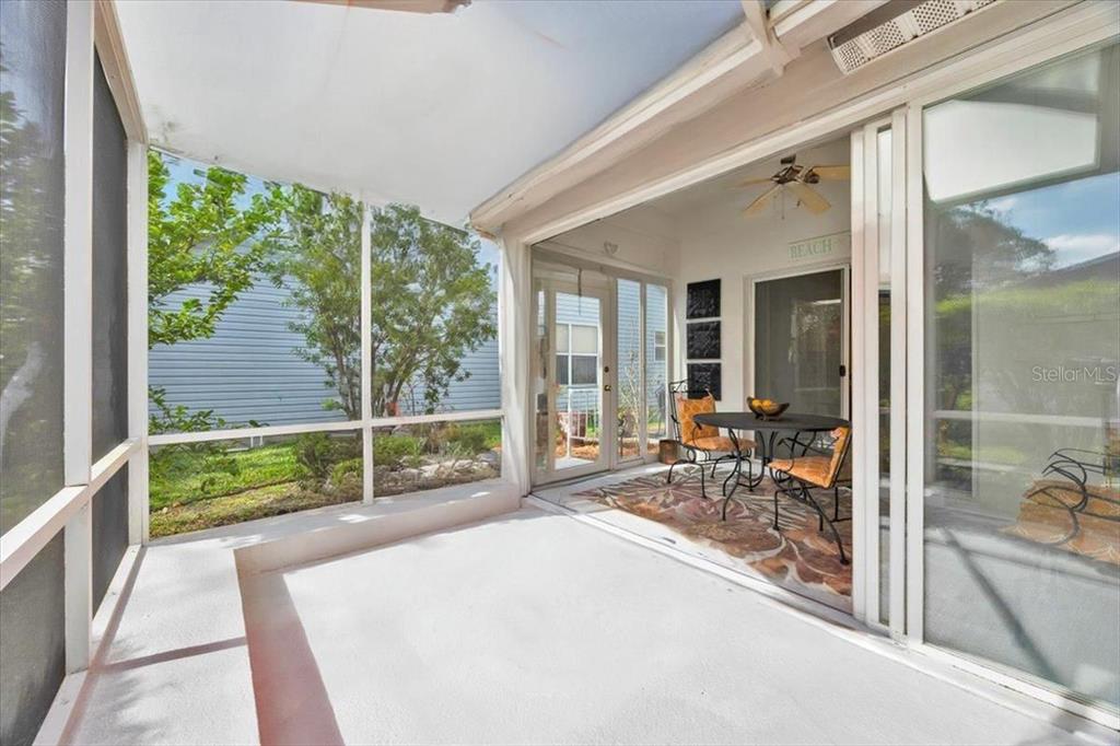 802 Miranda Way The Villages, FL 32159 - Photo 22 of 29 a room with trees in front of it