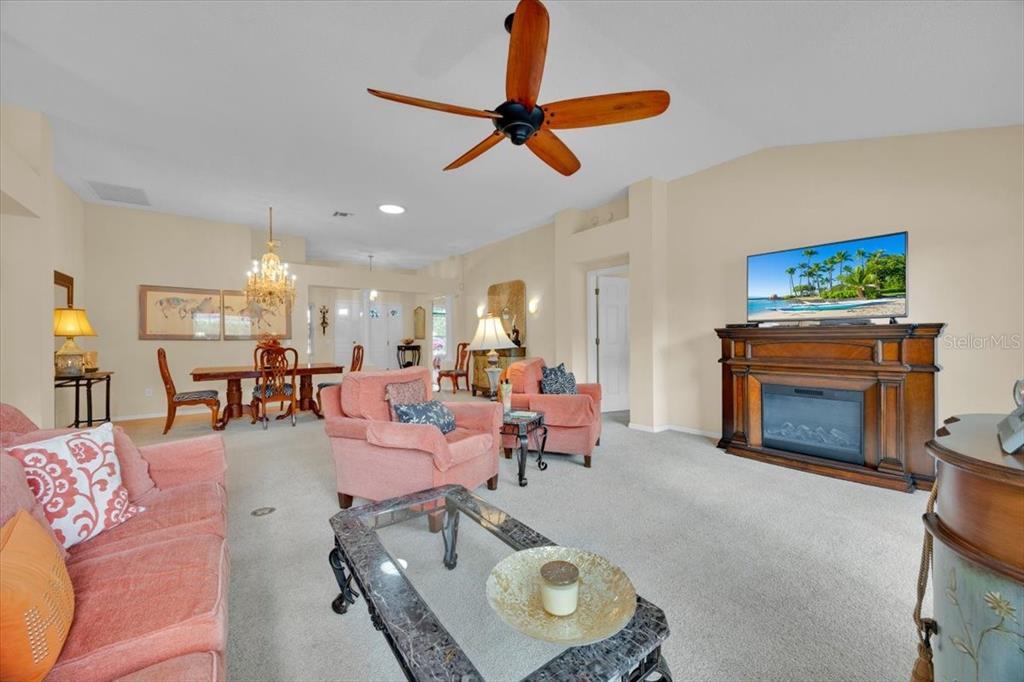 802 Miranda Way The Villages, FL 32159 - Photo 9 of 29 a living room with furniture a fireplace and a flat screen tv