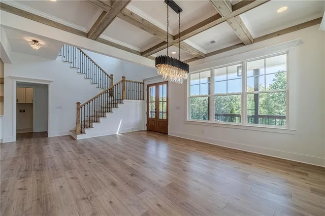 a view of an empty room with a fireplace and a window