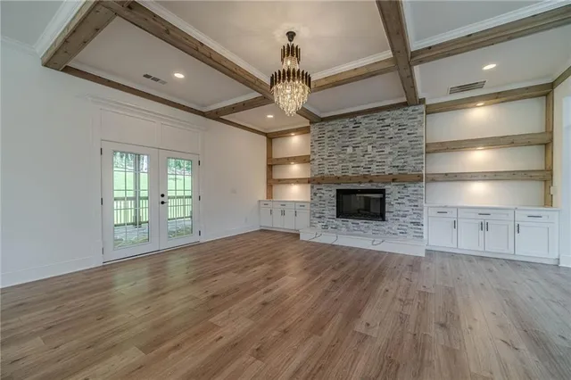 a view of empty room with wooden floor and fireplace