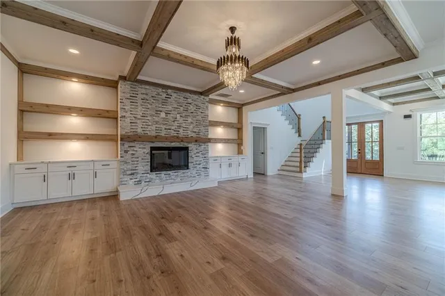 a view of a livingroom with furniture wooden floor and windows