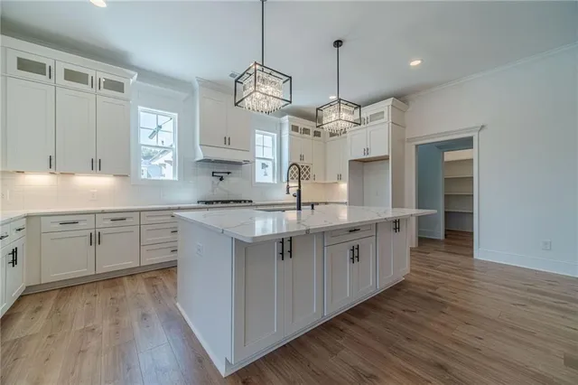 a large kitchen with stainless steel appliances granite countertop a stove and a sink