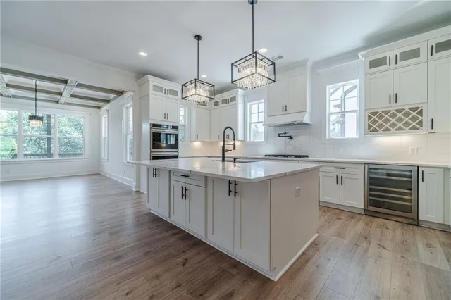 a view of a hallway with wooden floor and closet