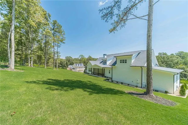 a front view of a house with a garden and yard