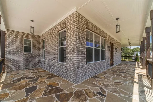 a view of a brick house with many windows