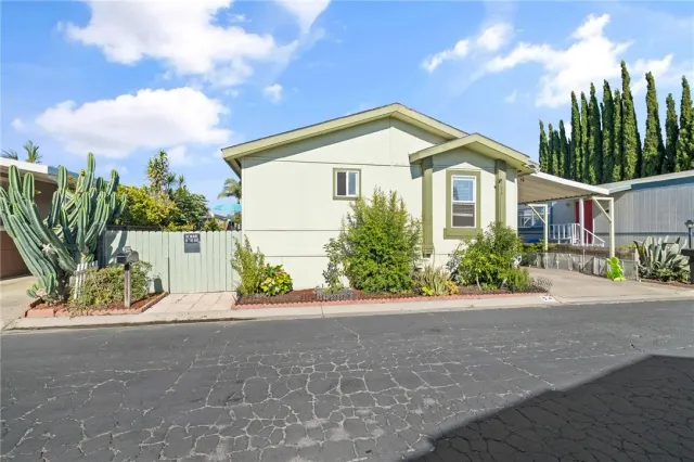 a front view of a house with a garden