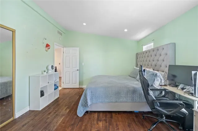 a bed room with a bed and a chair