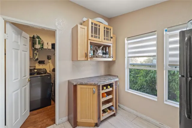 a kitchen with a refrigerator and a stove