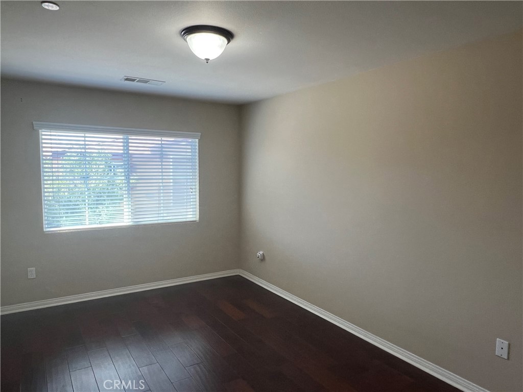 1510 Orange Avenue, Unit 902 Redlands, CA 92373 - Photo 16 of 29 an empty room with wooden floor and windows