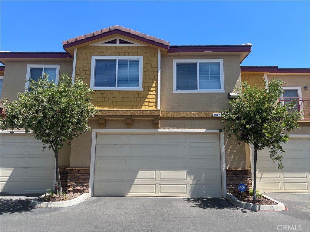 1510 Orange Avenue, Unit 902 Redlands, CA 92373 - Photo 4 of 29 a front view of a house with a yard and garage