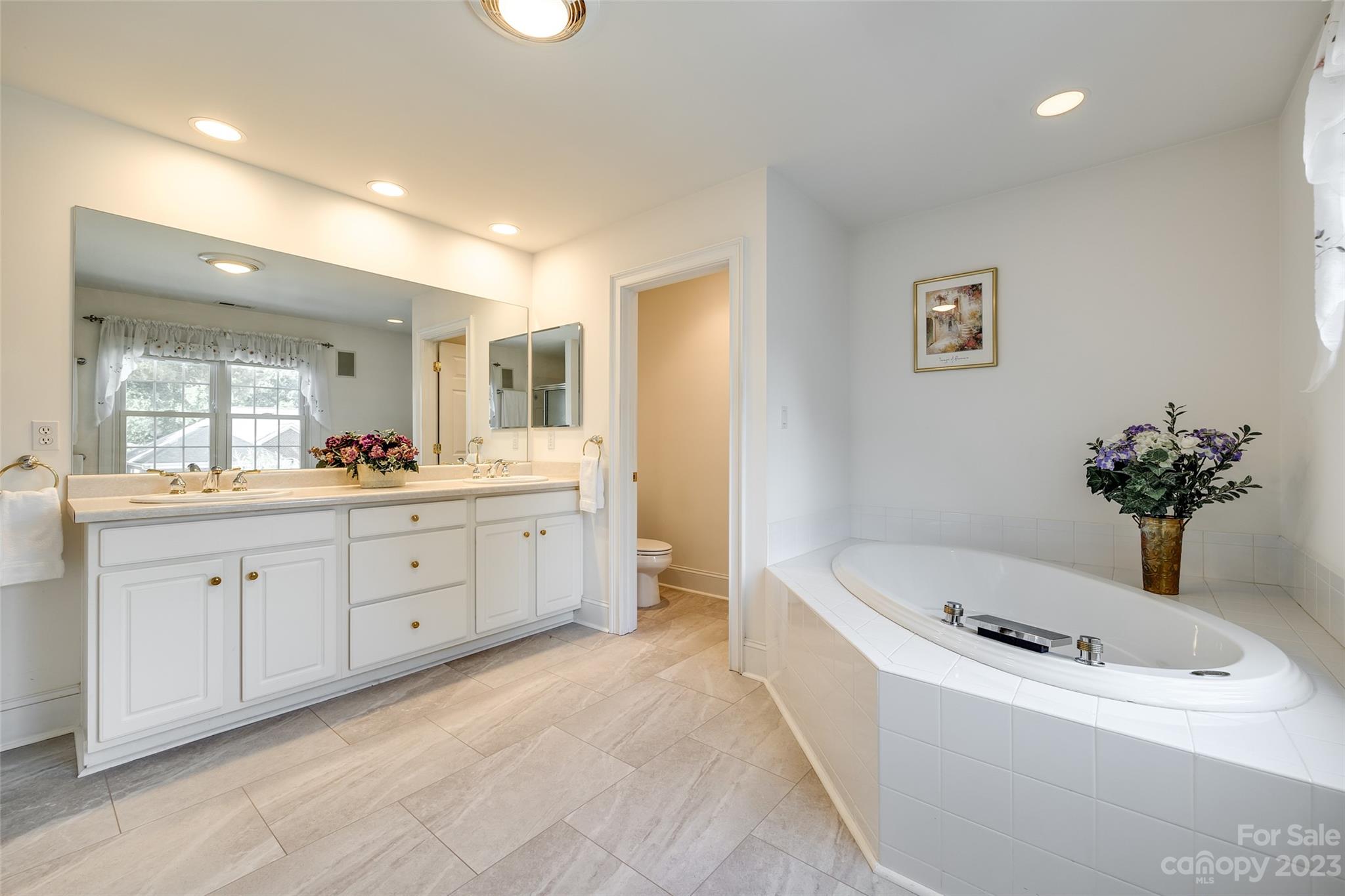 208 Chesterfield Canal Fort Mill, SC 29708 - Photo 28 of 48 a spacious bathroom with a tub sink and mirror