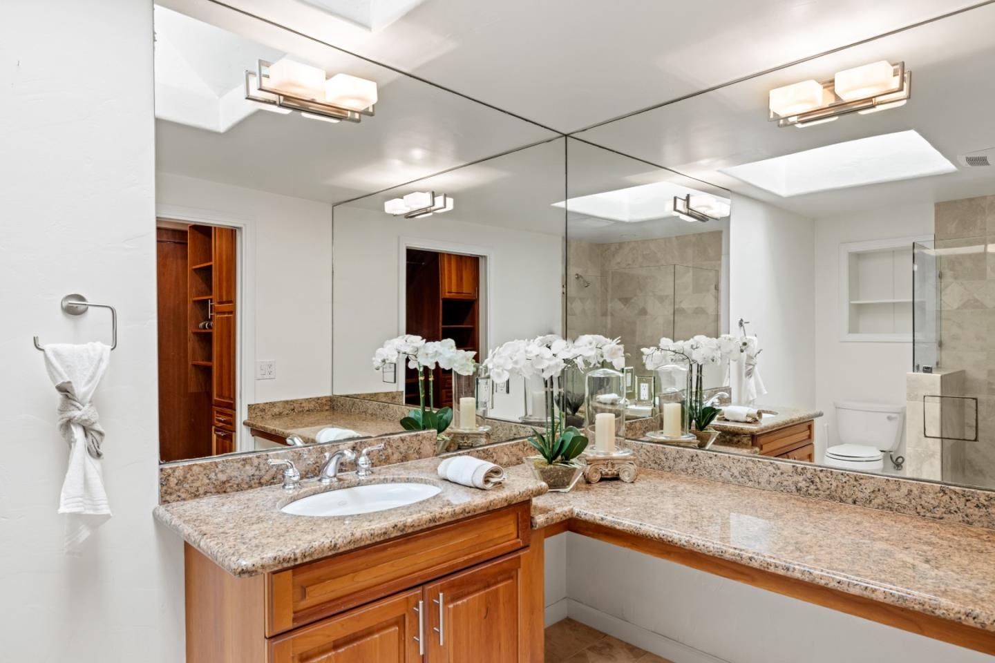 329 Stuart Avenue Pacific Grove, CA 93950 - Photo 12 of 21 a bathroom with a granite countertop sink and a mirror