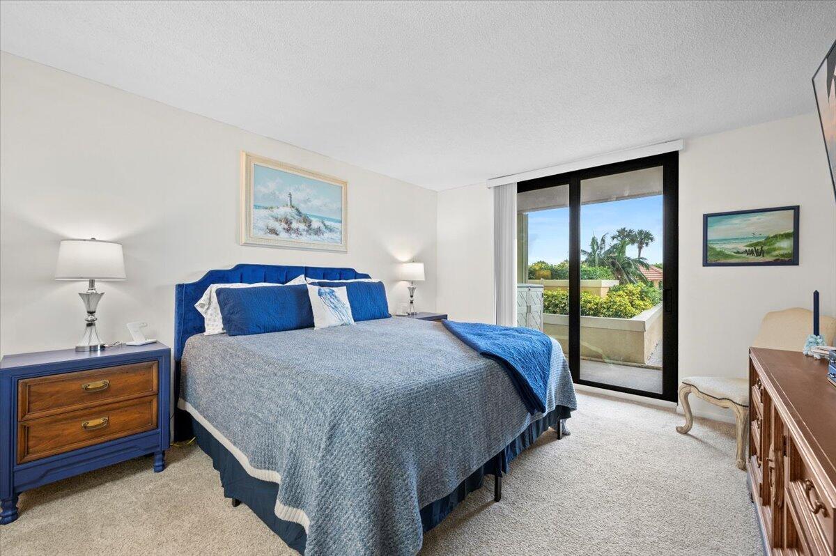 100 Ocean Trail Way, Unit 107 Jupiter, FL 33477 - Photo 15 of 34 Primary Bedroom with King Bed