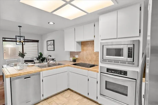 a kitchen with a sink stove and cabinets