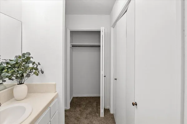 a bathroom with a granite countertop sink and a mirror