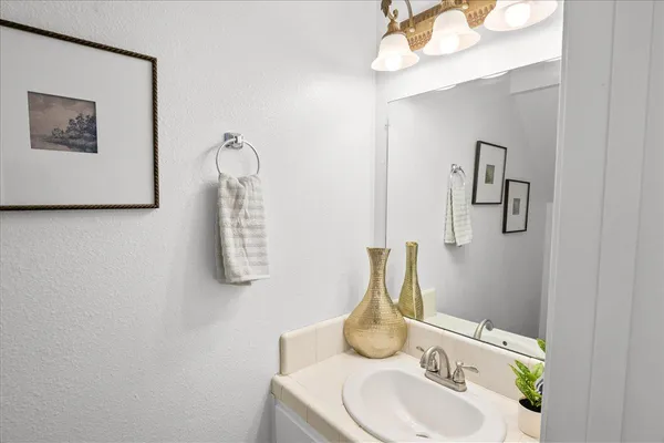 a bathroom with a sink and mirror