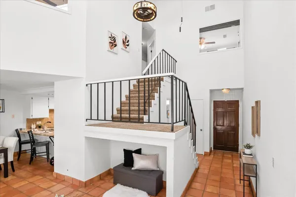 a view of a hallway with entryway wooden floor and front door