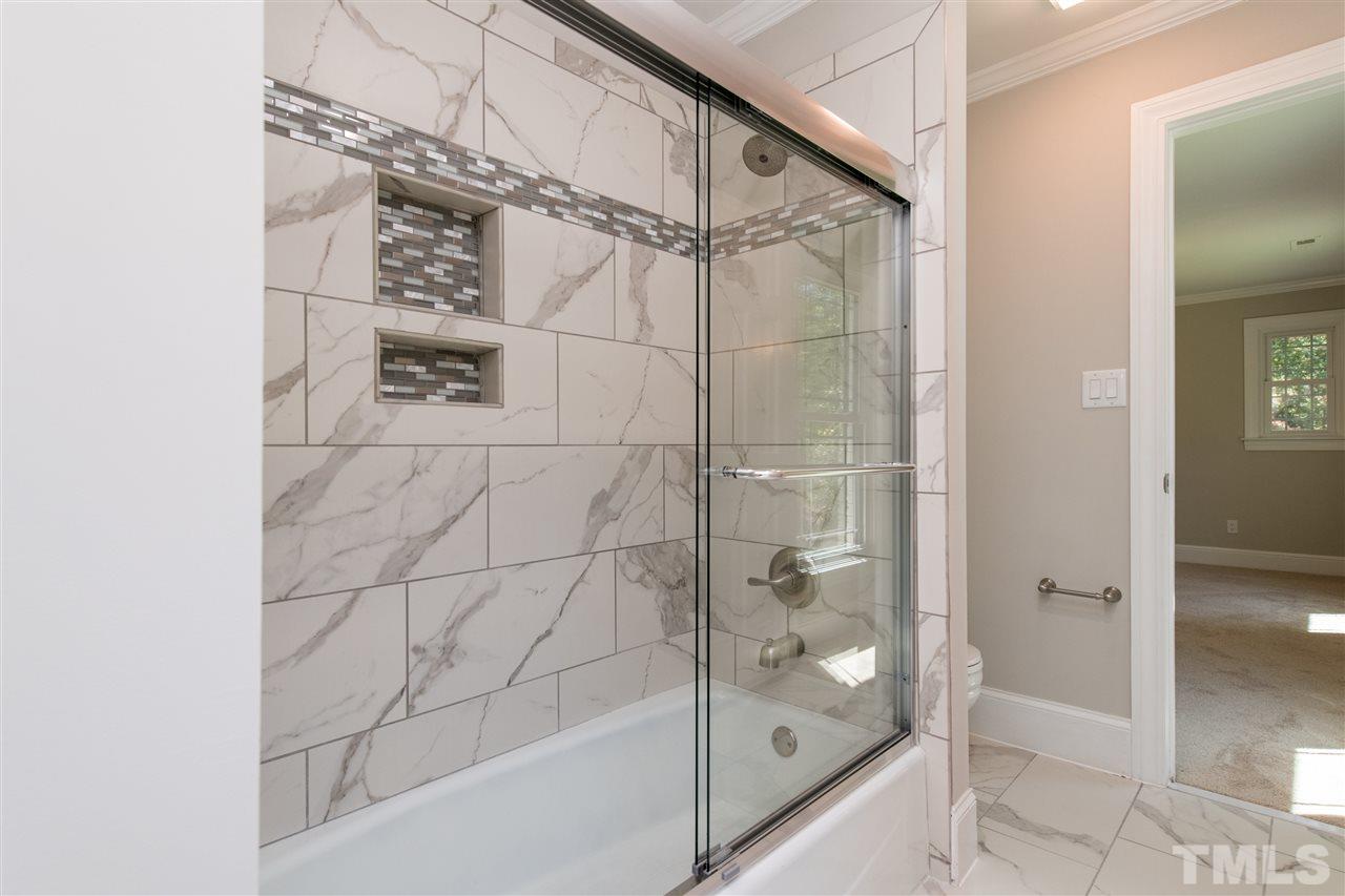 8804 Stage Ford Road Raleigh, NC 27615 - Photo 22 of 30 a bathroom with a glass shower door