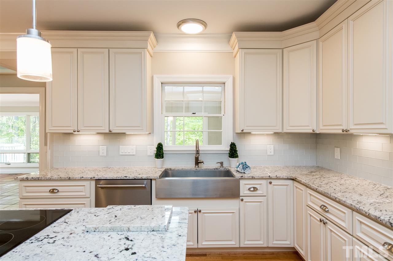 8804 Stage Ford Road Raleigh, NC 27615 - Photo 8 of 30 a kitchen with stainless steel appliances granite countertop a sink stove and cabinets