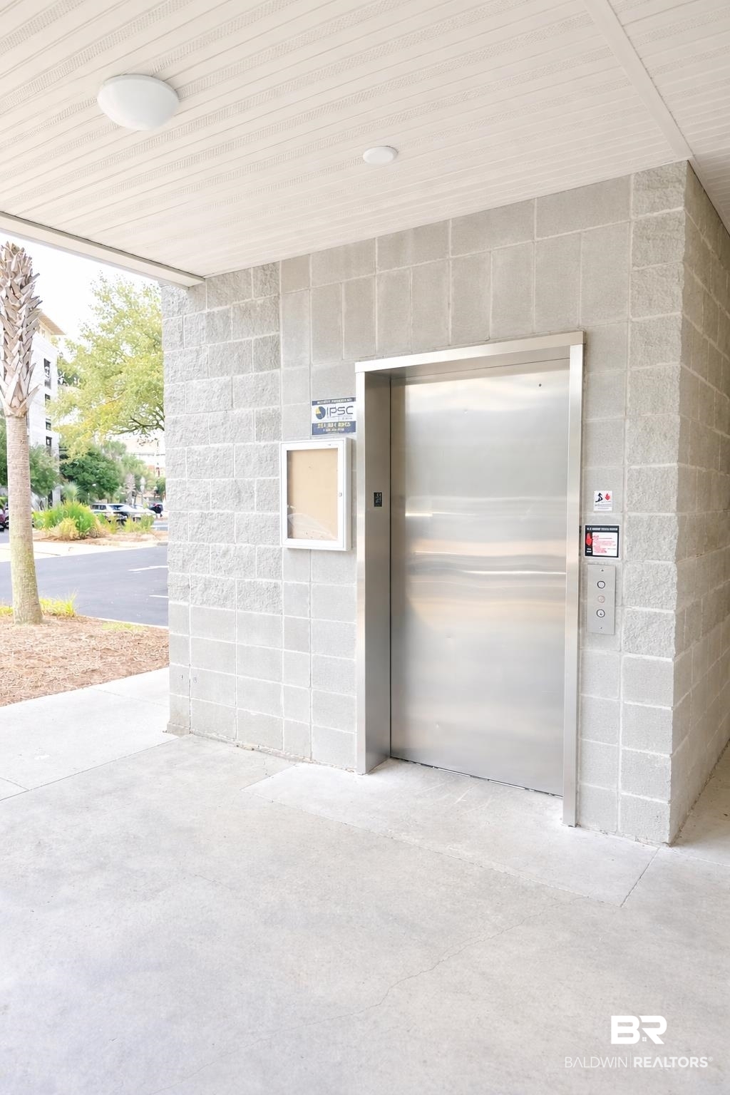 1430 Regency Road, Unit C101 Gulf Shores, AL 36542 - Photo 20 of 32 Property entrance with concrete block siding, elevator, and a porch
