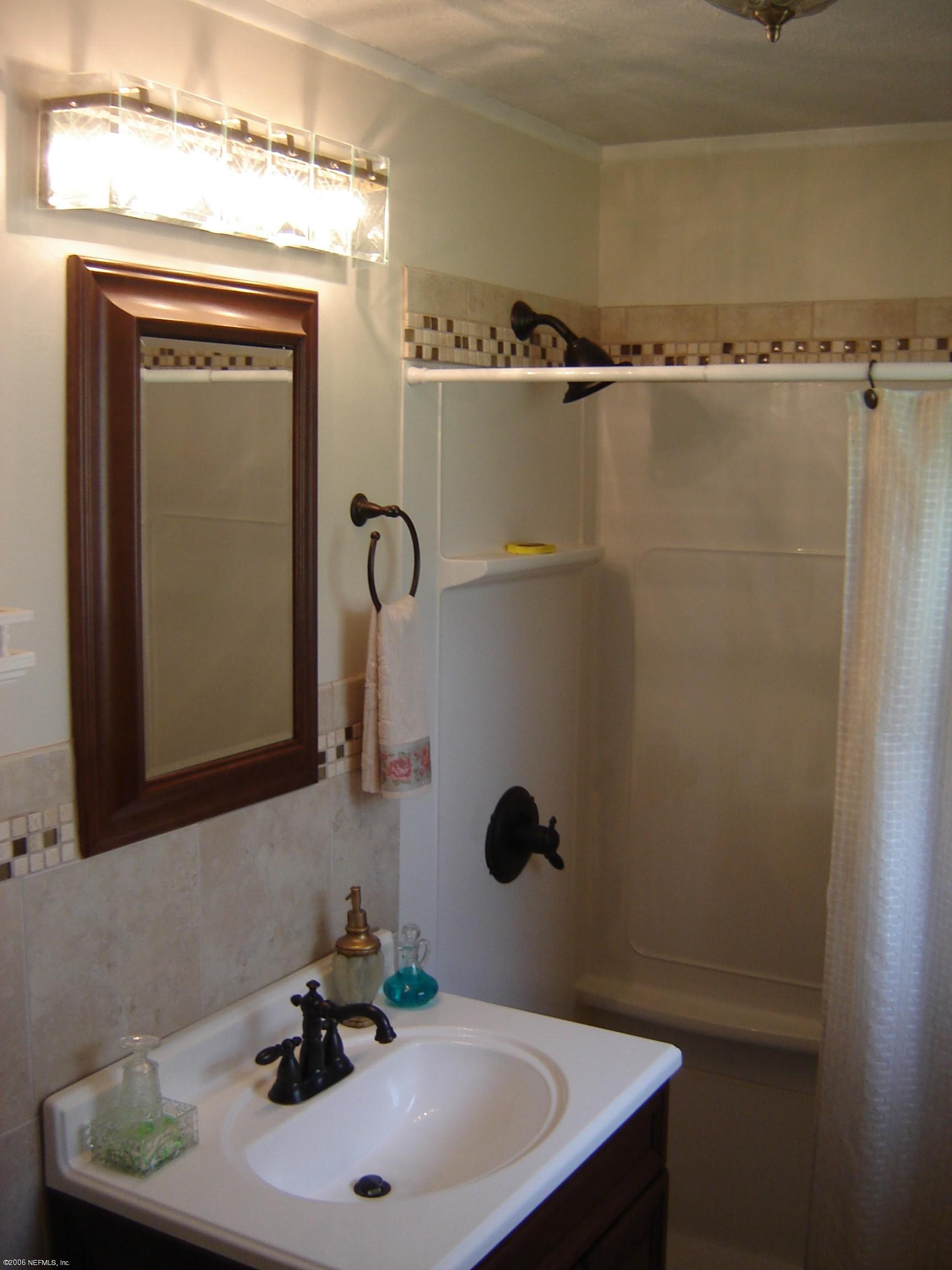 4170 Mustang Road Middleburg, FL 32068 - Photo 5 of 7 a bathroom with a sink and a mirror