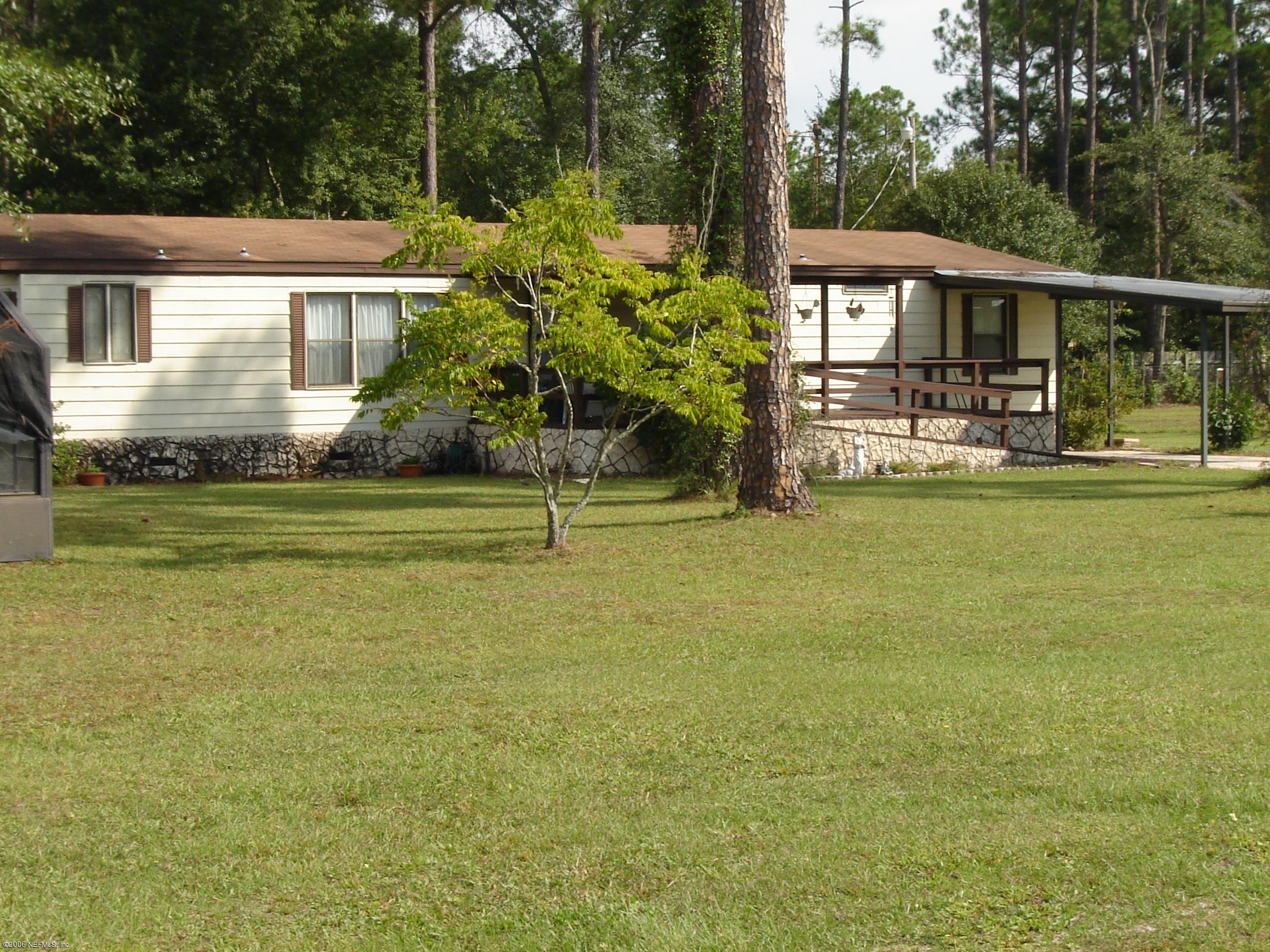 4170 Mustang Road Middleburg, FL 32068 - Photo 7 of 7 a view of a house with a swimming pool