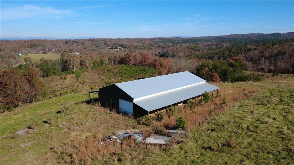 1350 Stivers Road Jasper, GA 30143 - Photo 29 of 70 a view of a big yard with an buildings in the background