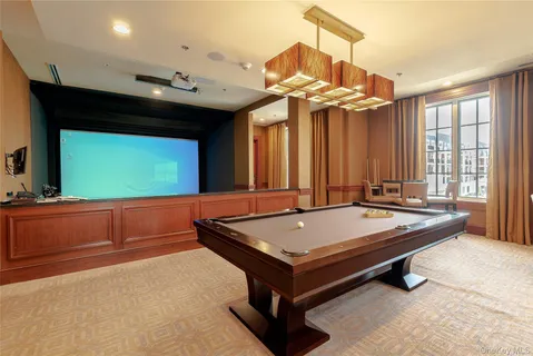 a room with pool table and windows