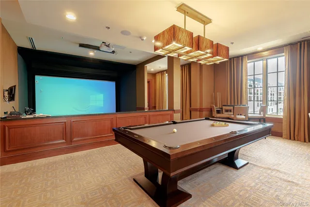 a room with pool table and windows